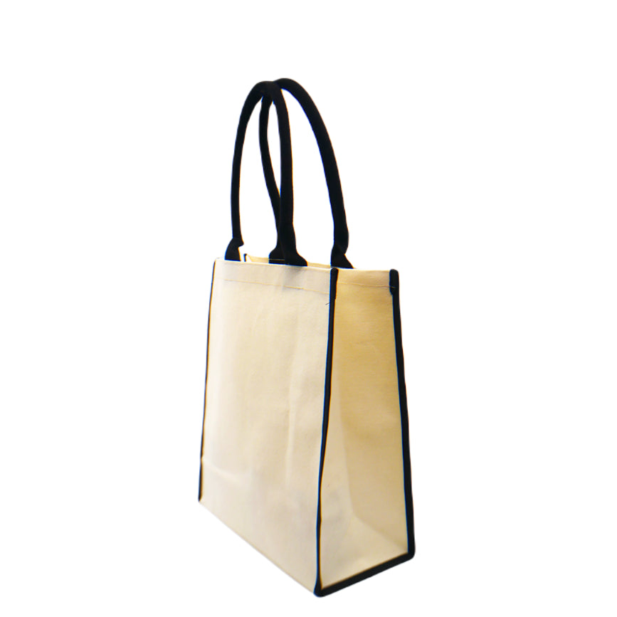 A side view of an eco-friendly canvas tote bag in black trimmings